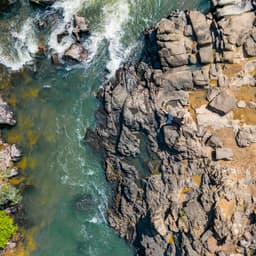 A picture of an aqua blue river and beautiful stone shoreline