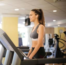 A young lady walking on a treadmill